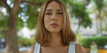 Serious woman looks at camera.
