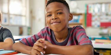 young boy in class learning
