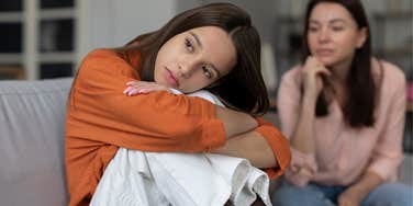 weak young girl turned away from mother 