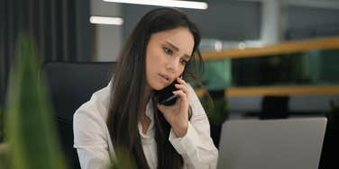serious woman on phone at work