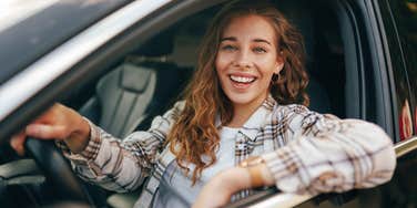 happy healthy woman smiling in her car