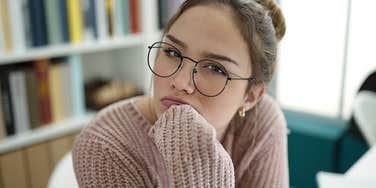 stressed and confused college student in the library