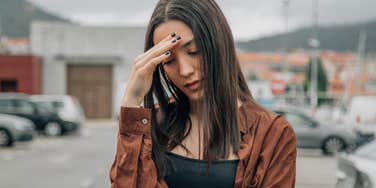 young woman covering face in shame embarrassed by appearance