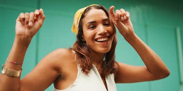confident woman dancing and smiling