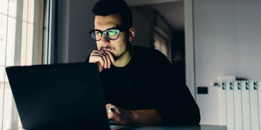 man using computer doing things do avoid job search burnout