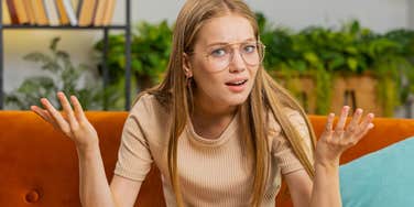young woman annoyed by financial choices of others