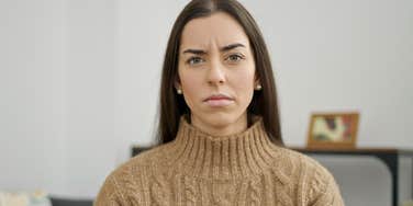 introverted woman looking stressed at home