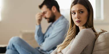 wife turned away from husband looking sad