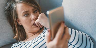 empathetic woman scrolling social media looking sad
