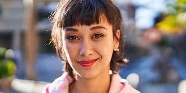 assertive young woman smiling confidently