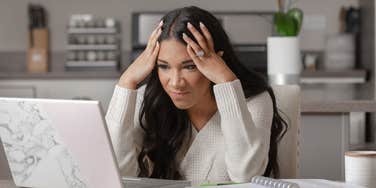 frustrated woman looking at laptop
