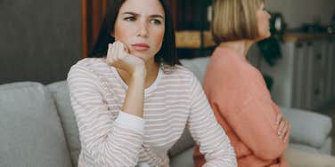 two women upset during argument facing away from each other