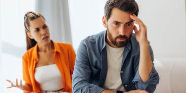 woman yelling at tired husband