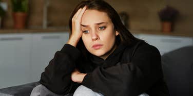 Sad woman watching the world fall apart. 