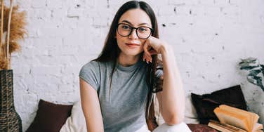 smiling content woman sitting in the same spot at home