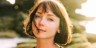 Calm person with a warm smile, showing types of people who naturally heal and uplift everyone around them.