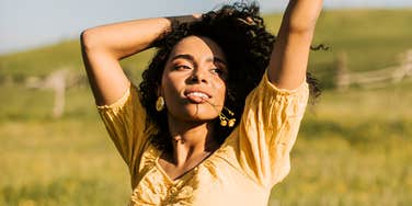Woman relaxing on a meadow, illustrating simple ways to embrace hygge and live a happy, peaceful life