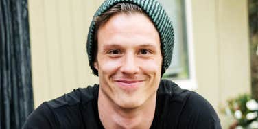 Kind-looking man in a beanie, demonstrating small daily gestures that can positively impact someone’s life