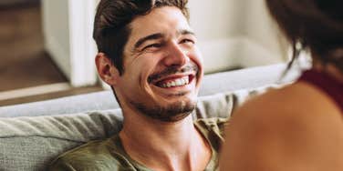Man smiling in a couple where they've prioritized all types of intimacy