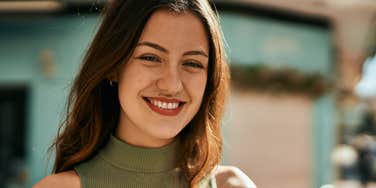 woman smiling becoming a better person than she thinks