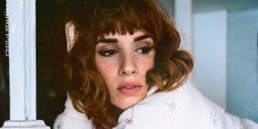 Bored woman staring off thoughtfully, symbolizing emotional emptiness and the quiet realization that something’s missing in her relationship.