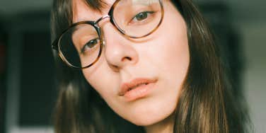 serious young woman unwilling to buy simple things for herself