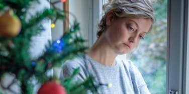 lonely sad woman feeling bittersweet during holiday seasons