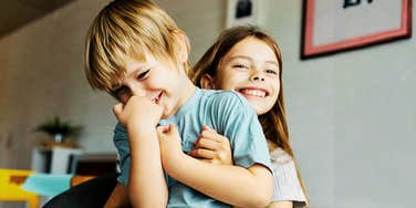 Boy and girl friends playing and laughing, but not at the old-fashioned joke 
