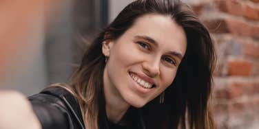 happy woman smiling handling life's difficulties with ease
