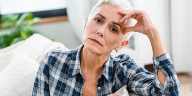 sad older woman with no social life sitting at home
