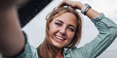 fearless woman smiling taking a selfie