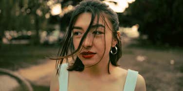 Pensive person looking down, illustrating the mental mistakes that keep people insecure and stuck in self-doubt for life