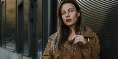 classless woman standing on the street looking serious