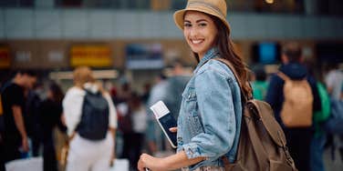 smiling woman waiting to board a plane at the airport