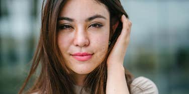 peaceful woman smiling touching her hair