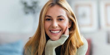 resilient woman smiling after surviving rock bottom