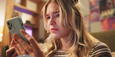 people-pleasing woman worried texting on phone