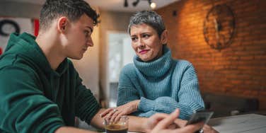 mom talking to her college age son at table