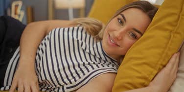 happy woman sleeping alone in bed