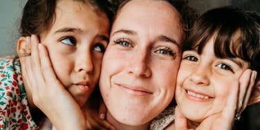 Mother engaged with her children in a loving and attentive way, representing natural maternal instincts, parenting best practices, and emotional connection in motherhood.