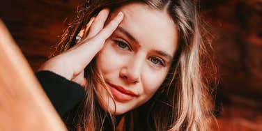 Confident, self-assured woman smiling calmly, embodying the simple habits of naturally secure people