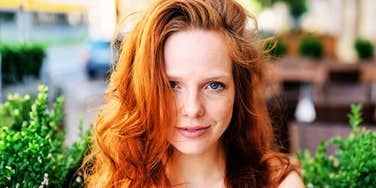 Calm, compassionate woman smiling softly, representing the small acts that can transform the life of someone with anxiety