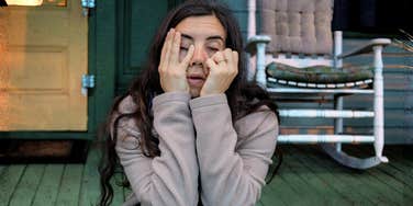 Exhausted overwhelmed person resting their head on their hand showing the art of feeling human again and the hidden reasons people feel so exhausted.