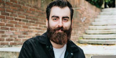 Smiling man outdoors showing the art of unlocking limitless genius