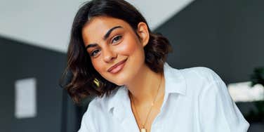 Confident professional receiving positive recognition at work showing the art of getting promoted and the habits of naturally promotable people