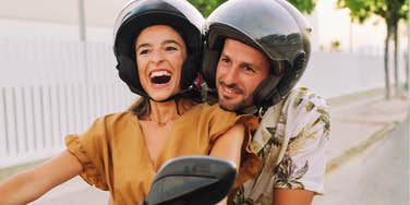 Confident, secure girl riding a motorcycle showing the art of being secure and habits of people who aren’t frantic about being loved.