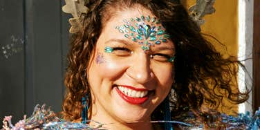 Confident, whimsical woman showing the art of pixie dust and habits that make all dreams come true.