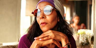 Calm, poised unbothered person seated outdoors in a strong stance, illustrating the unshakable confidence and daily habits of people who never doubt themselves