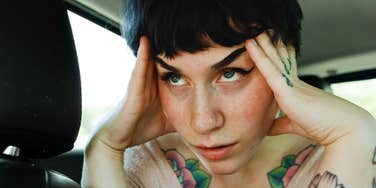 Overwhelmed person pausing for a grounding moment showing the tiny calming fixes to try before you spiral from stress and anxiety.