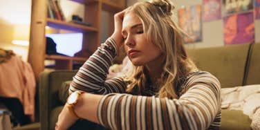 brilliant woman stressed out in cluttered room